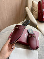 Burgundy leather mule loafers with gold-tone horsebit and dark insoles