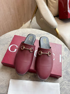 Burgundy leather mule loafers with gold-tone horsebit detail and black insoles
