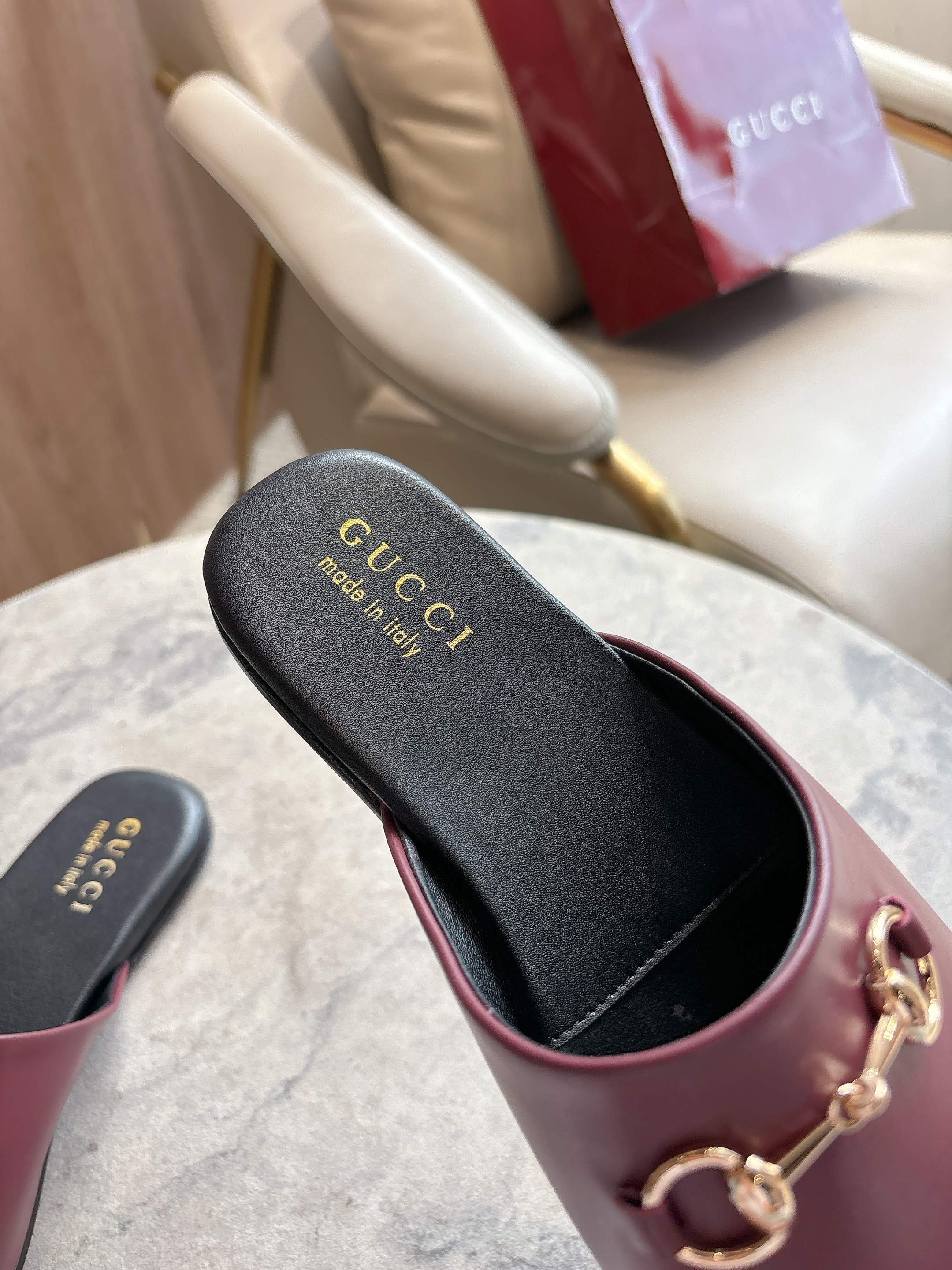 Burgundy leather mule front view with gold-tone horsebit and black insole