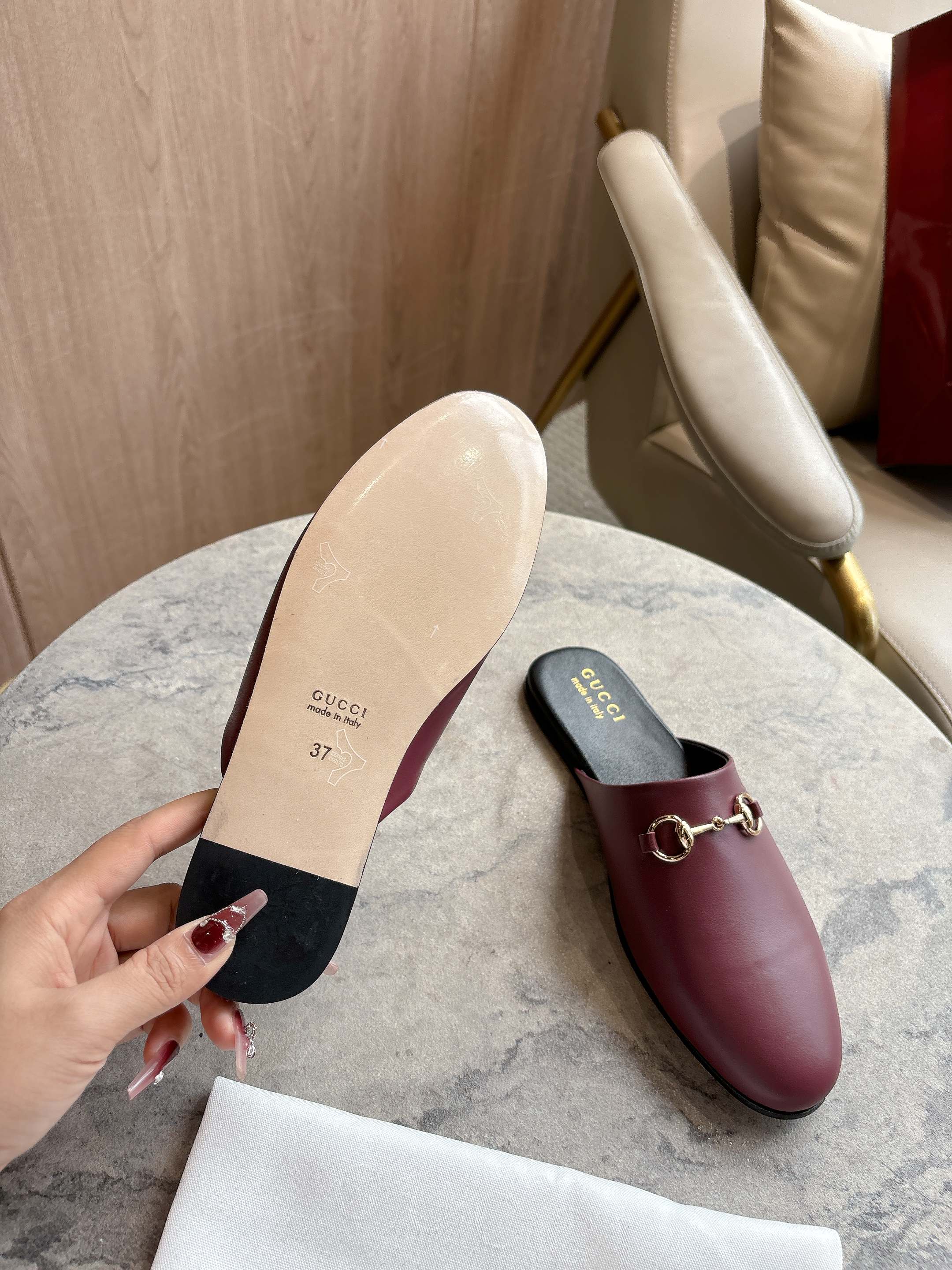 Burgundy leather mule loafers with gold-tone horsebit and light tan sole