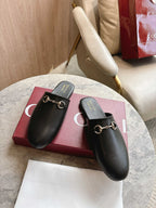 Black unisex loafers with gold chain buckle and cushioned footbed
