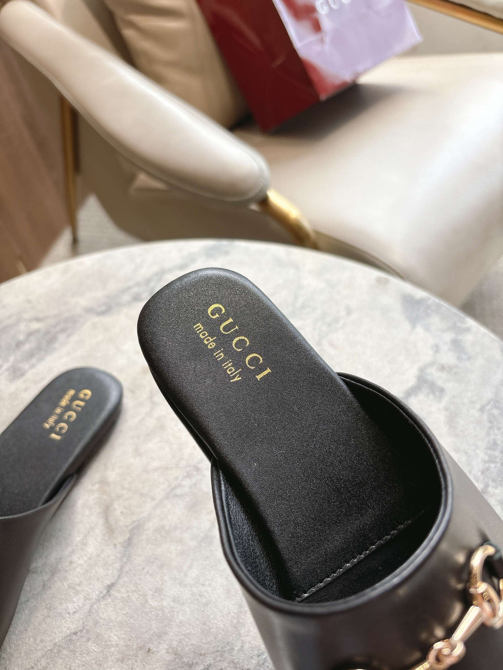 Black unisex slides with Gucci logo on dark footbed and stitched trim