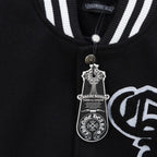 Black varsity jacket close-up with ribbed striped collar and snap button