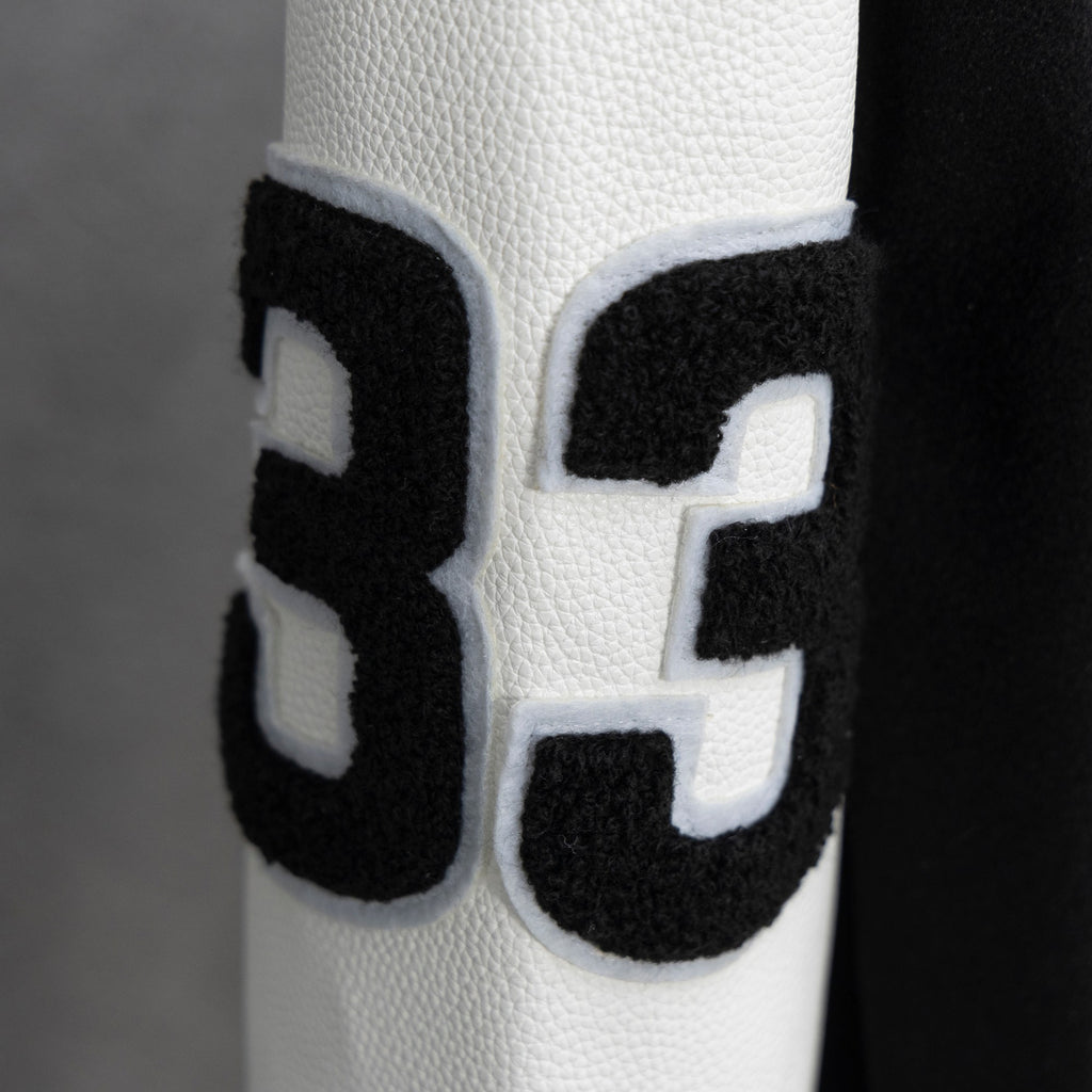 Black-and-white varsity jacket sleeve with large number 3 applique patch