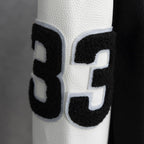 Black-and-white varsity jacket sleeve with large number 3 applique patch