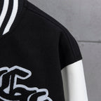 Black and white varsity jacket close-up with ribbed striped collar trim