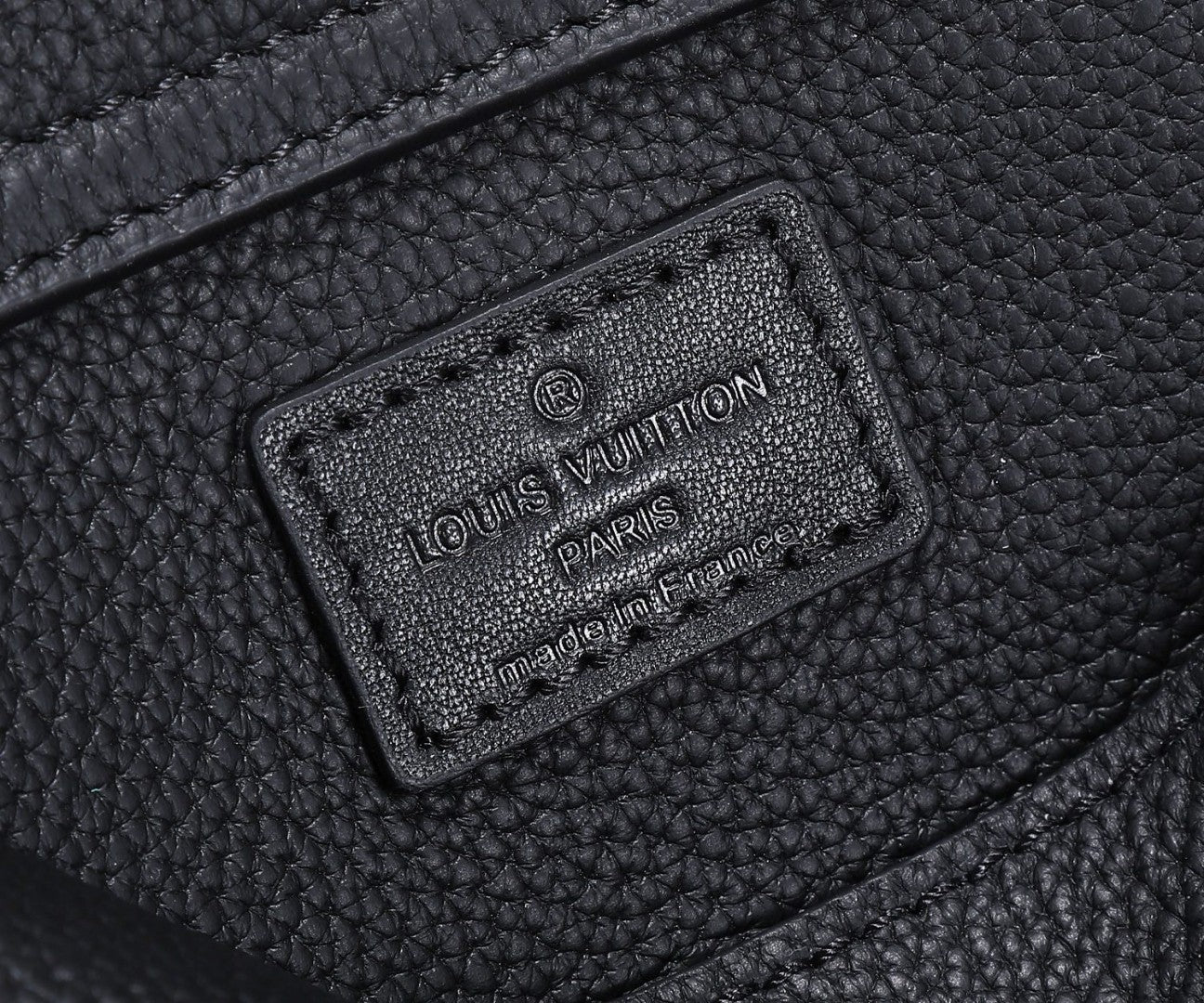Black leather belt bag interior patch with Louis Vuitton Paris branding