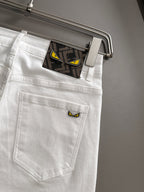 White denim pants close-up of back pocket with stitched seam and hanger