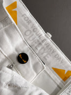 White denim pants close-up of inner label and waistband button closure