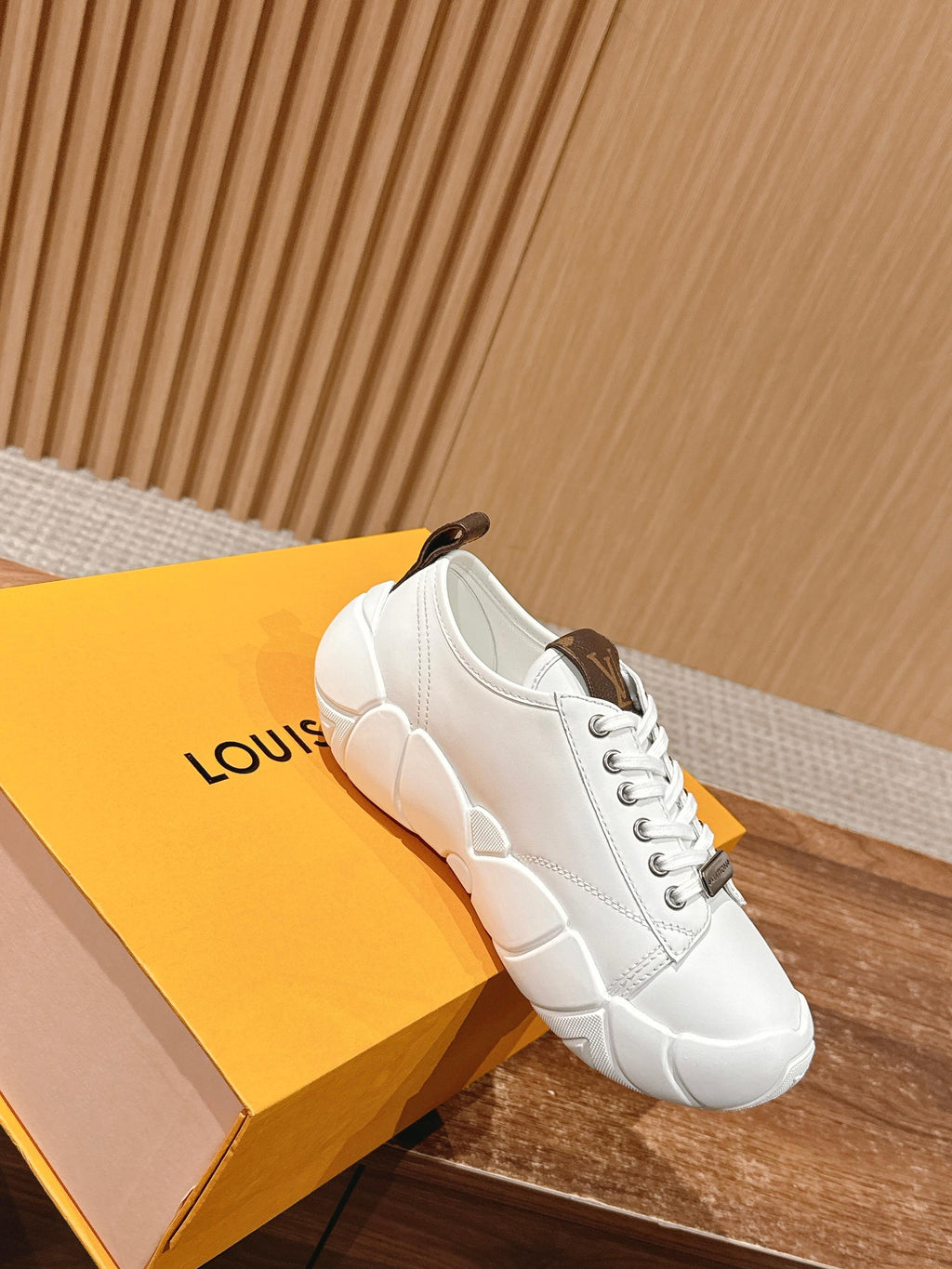 Louis Vuitton unisex sneaker in white leather with white laces and brown interior collar