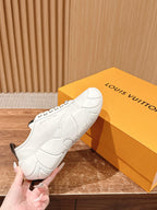 Louis Vuitton unisex sneaker held by hand, white leather with chunky molded sole