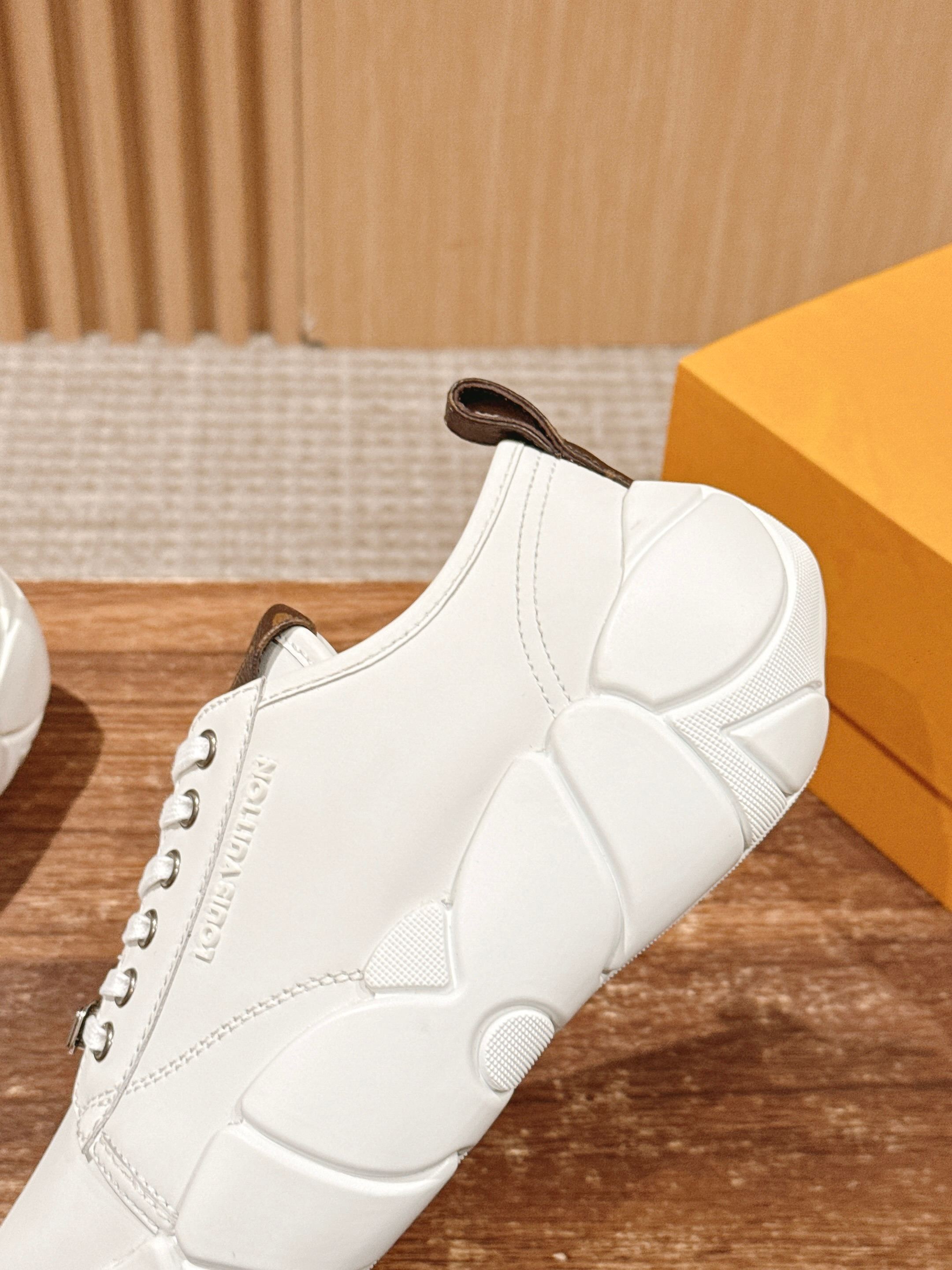 Louis Vuitton unisex sneaker side profile, white leather with brown lace stay detail