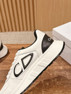 Dior unisex sneakers side view, white upper with black logo patch and chunky sole