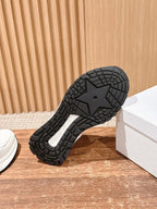 Dior unisex sneakers outsole view, black tread sole with grid pattern