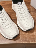 Dior unisex sneakers close-up, white leather with perforations and white laces