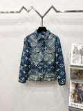 Blue denim jacket with white monogram pattern, button front and chest pockets