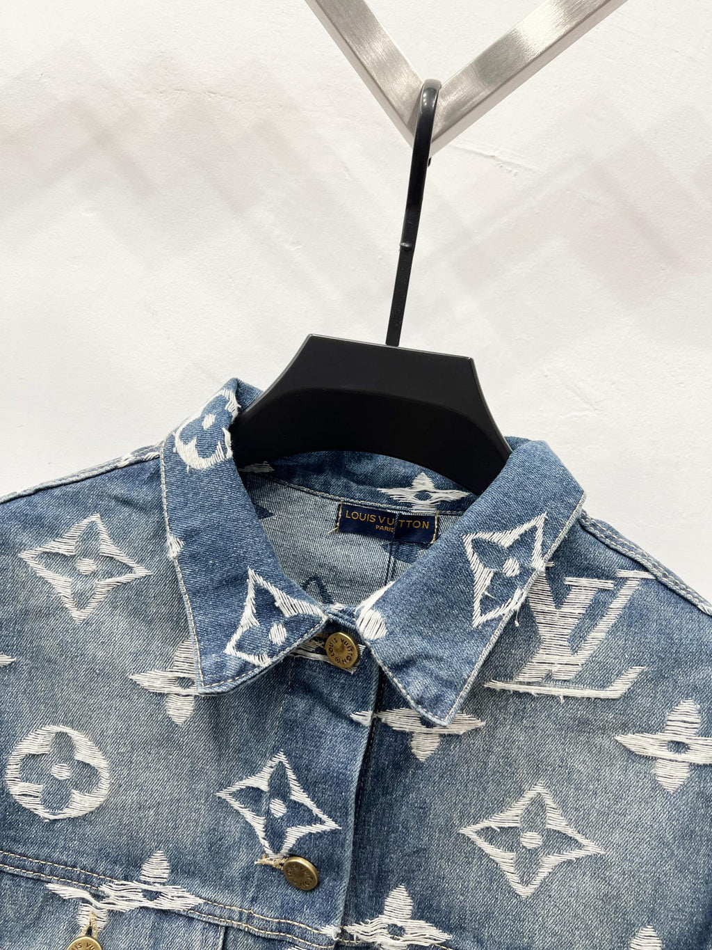 Blue denim jacket with white monogram, point collar and gold button placket