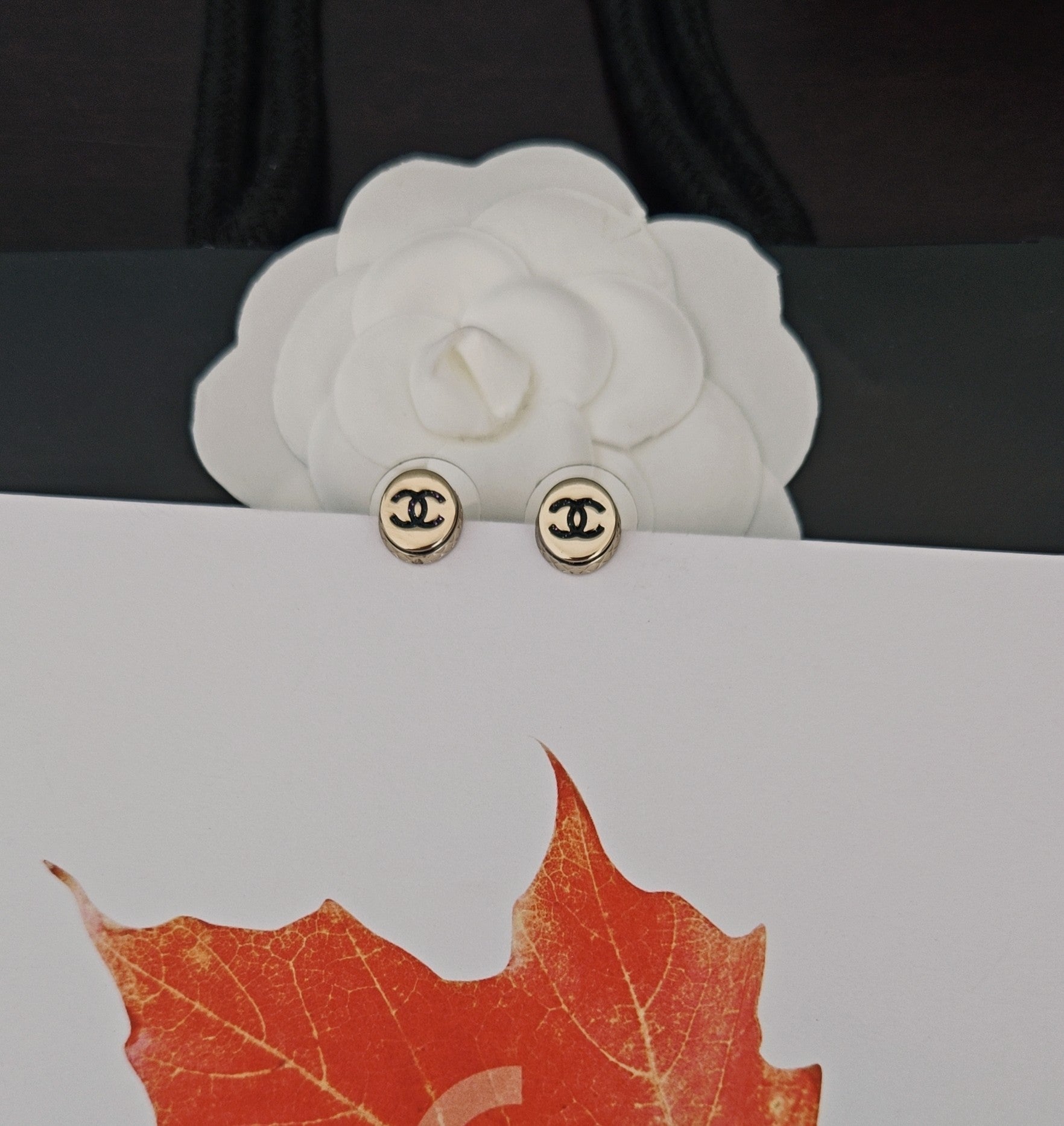 Gold-tone Chanel CC stud earrings, round with black logo on posts