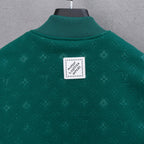 Long-sleeve jacket back, dark green knit with square logo patch at center.
