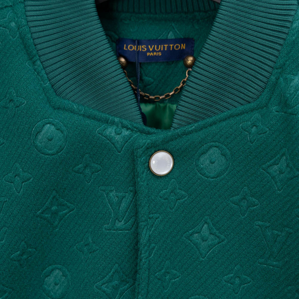 Long-sleeve jacket front detail, ribbed knit collar and centered round snap button.