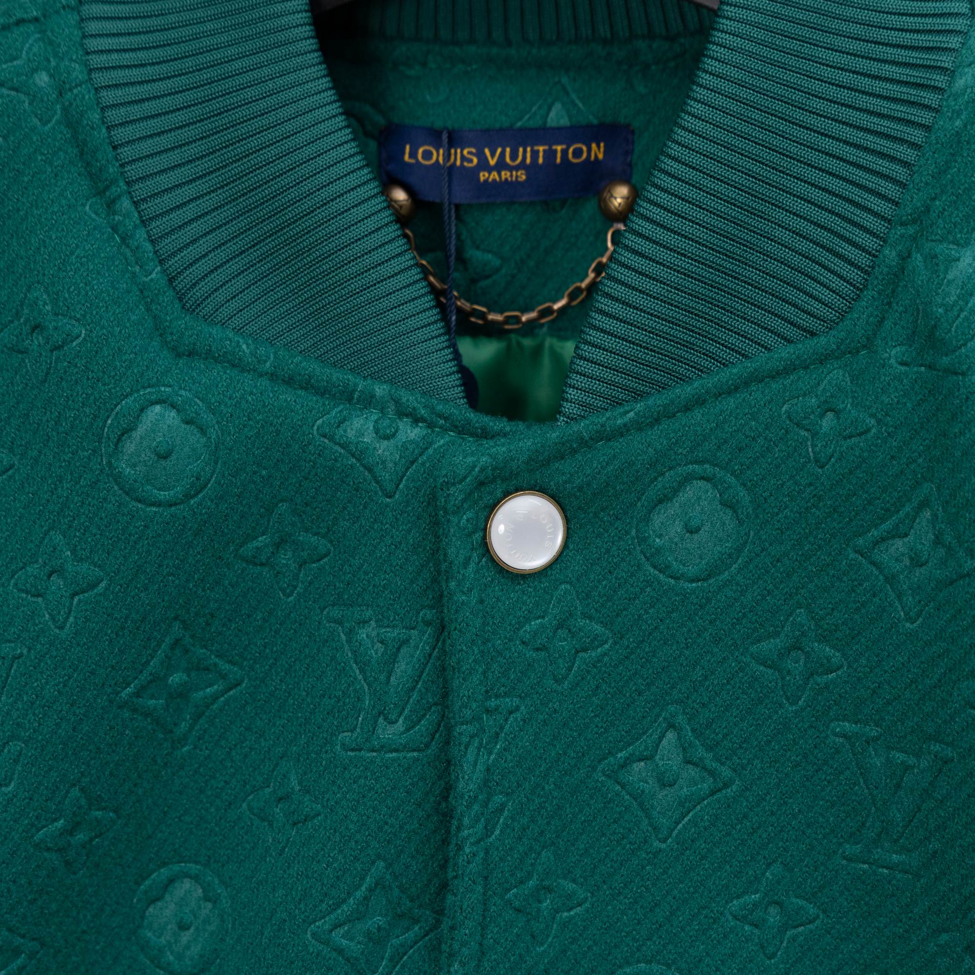 Long-sleeve jacket front detail, ribbed knit collar and centered round snap button.