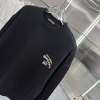 Black crewneck sweatshirt with ribbed collar and multicolor chest logo.
