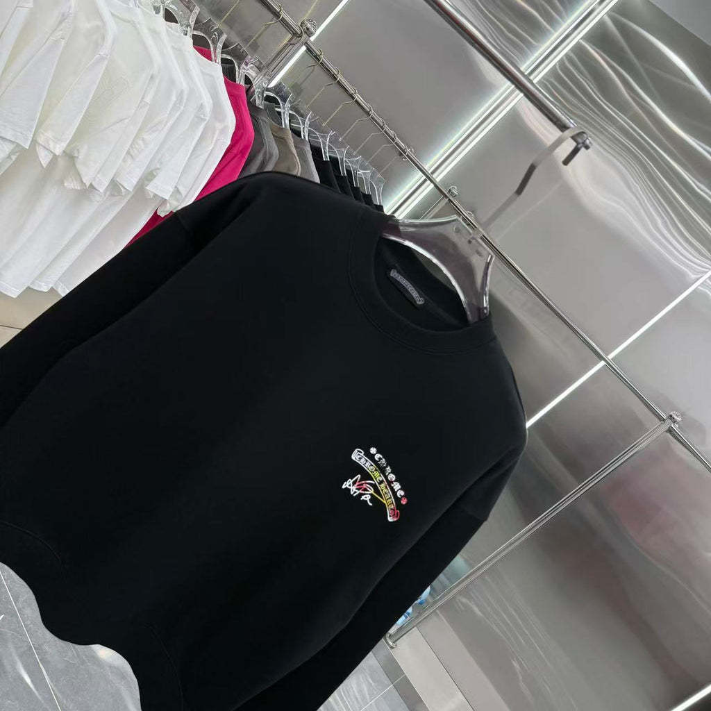 Black long-sleeve crewneck sweatshirt, chest logo with multicolor details.
