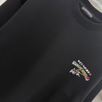 Black sweatshirt with embroidered-style multicolor chest logo detail.