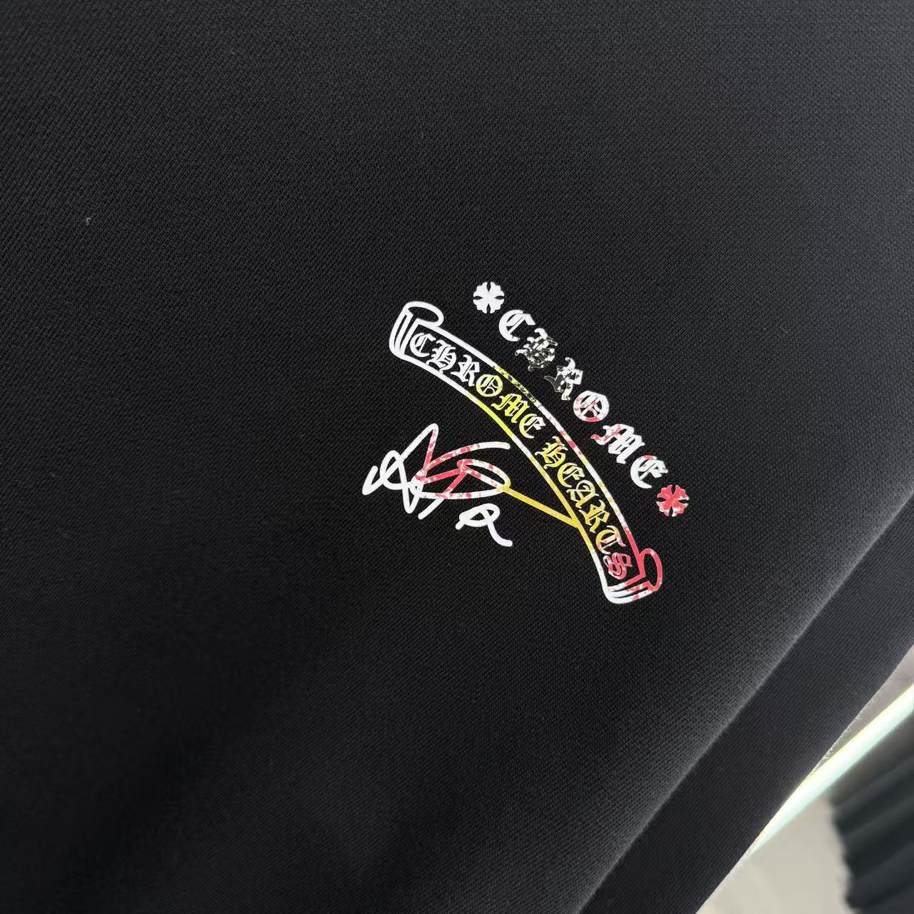 Black sweatshirt with multicolor embroidered-style logo on chest.