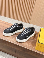 Pair of black Fendi lace-up sneakers with white platform soles and logo accents
