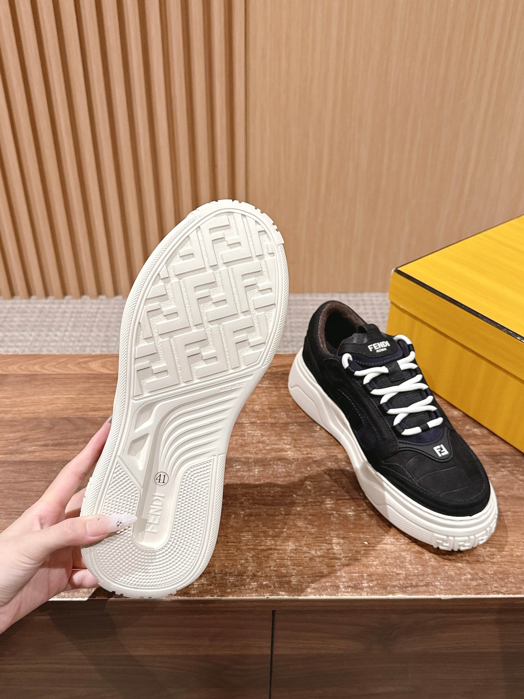 Black Fendi sneakers with white outsole, side laces, and logo details