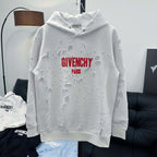 White Givenchy hoodie with red “GIVENCHY PARIS” logo and textured patches across front