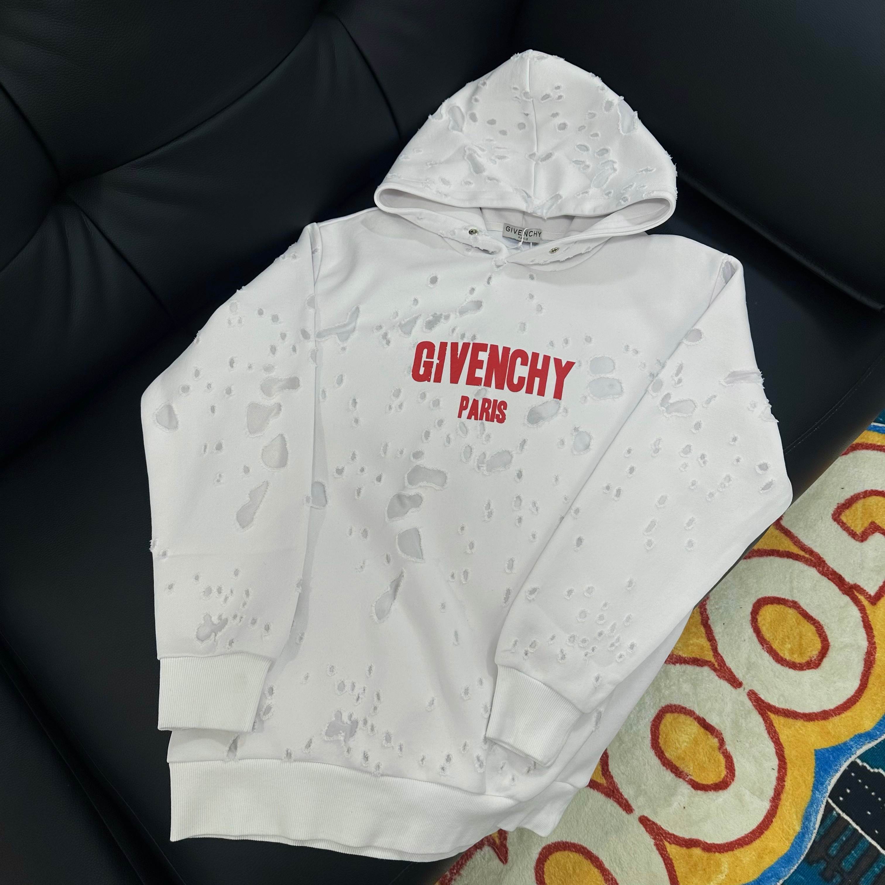 White Givenchy hoodie with red “GIVENCHY PARIS” logo on chest and hood