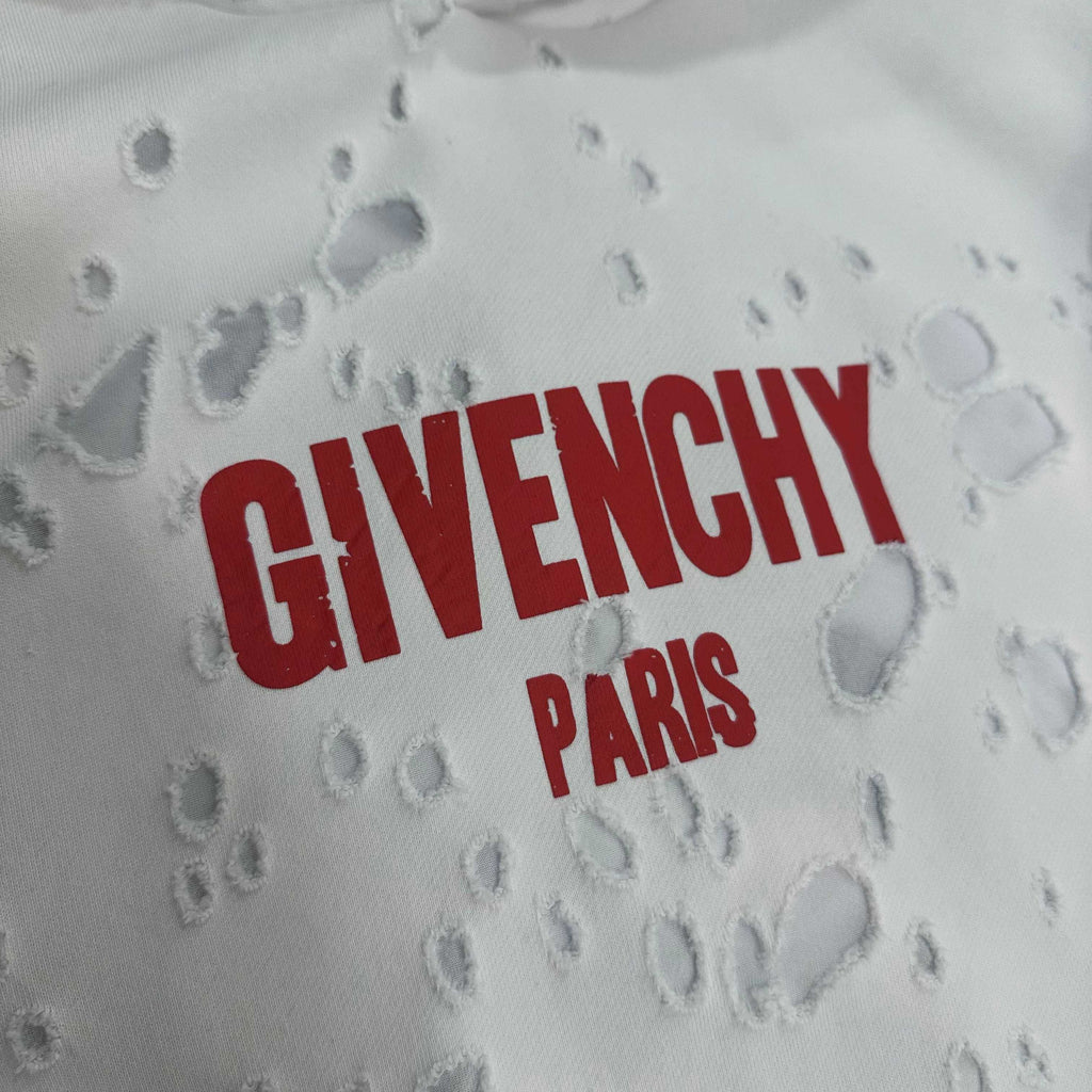 White Givenchy hoodie fabric close-up with red “GIVENCHY PARIS” text