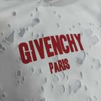 White Givenchy hoodie fabric close-up with red “GIVENCHY PARIS” text