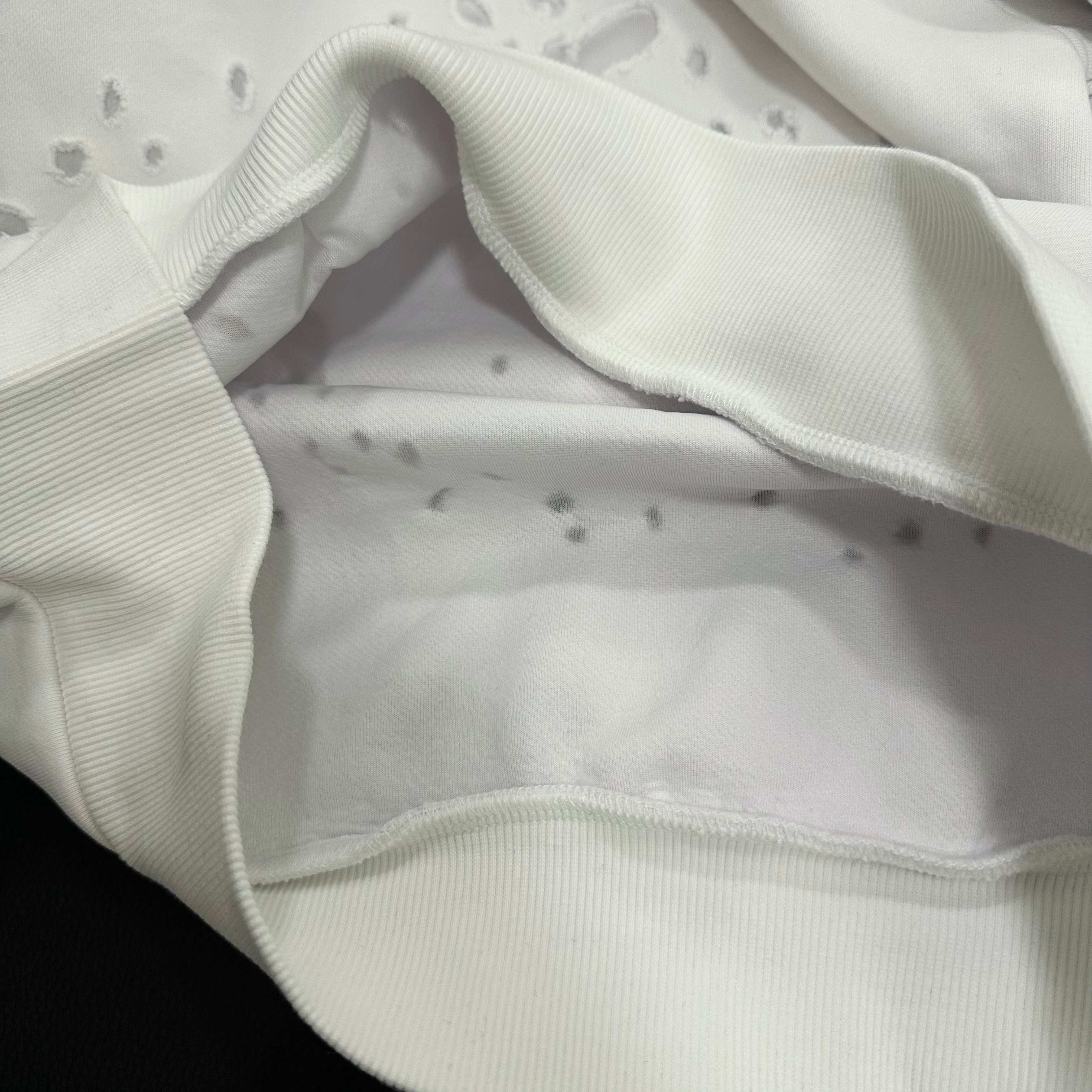 White Givenchy hoodie pocket and hem detail with ribbed trim