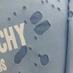 Light blue hoodie fabric close-up with raised paw-print graphic