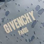 Light blue hoodie fabric close-up with 'GIVENCHY PARIS' text and paw prints