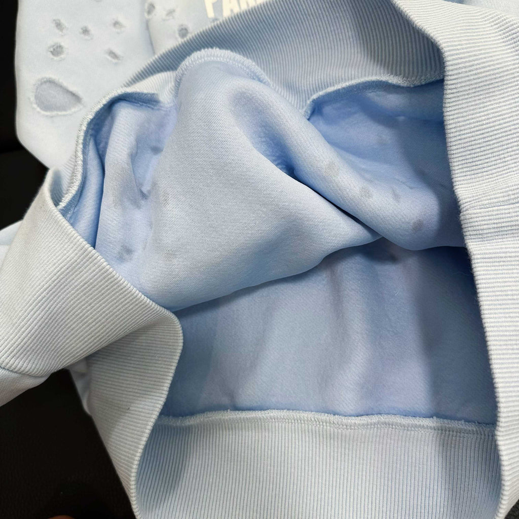 Light blue hoodie hood lining with ribbed trim and paw-print fabric