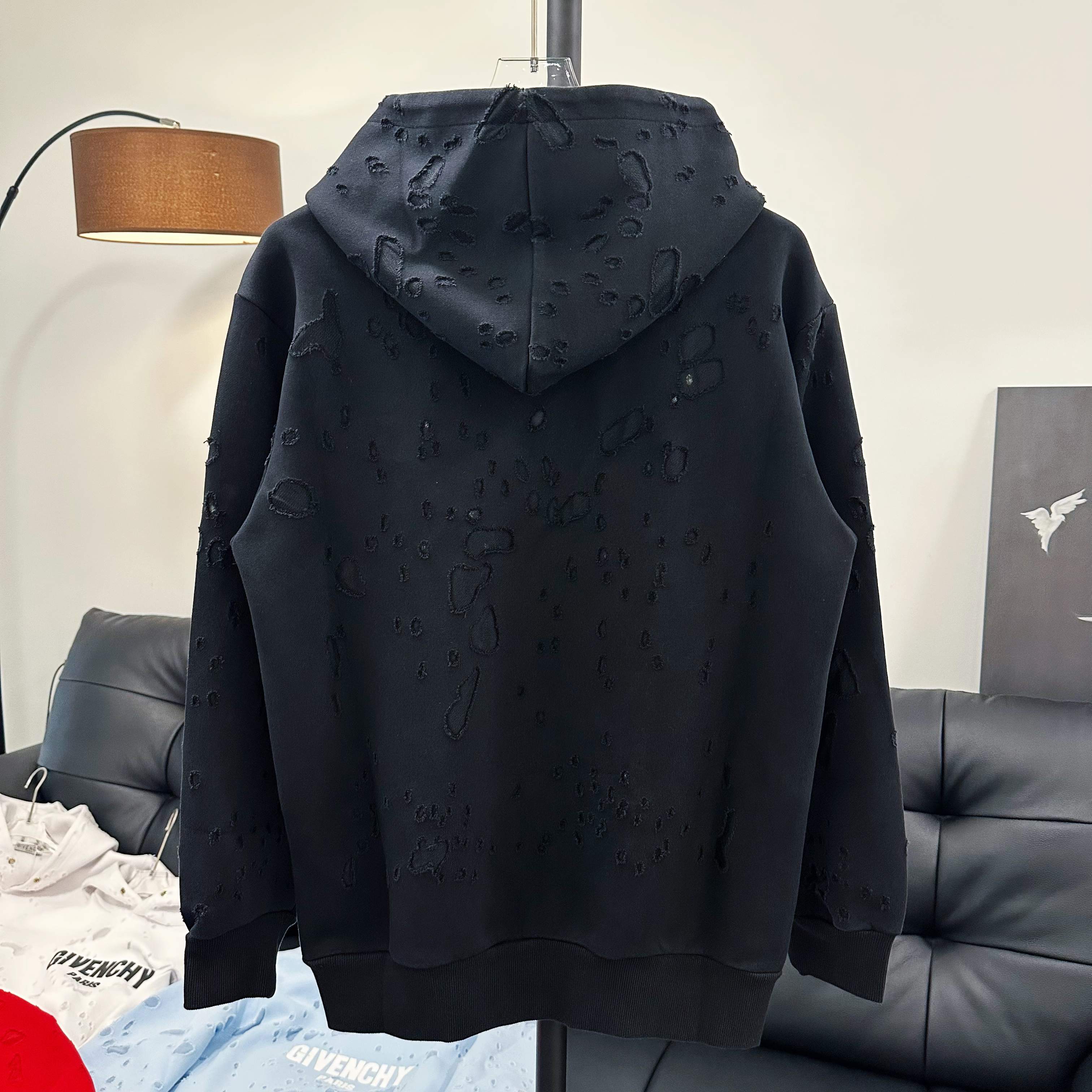 Black Givenchy hoodie with hood and scattered embossed logo pattern