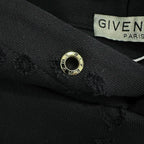 Black hoodie cuff detail with gold snap button and partial Givenchy Paris label