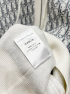 Dior long zip-up hoodie fabric care label on cream knit near the hood