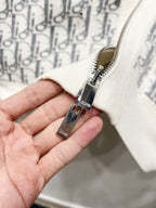 Dior long zip-up hoodie zipper close-up with silver hardware on monogram print