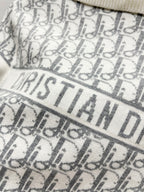 White Dior monogram knit fabric with 'CHRISTIAN DIOR' text detail