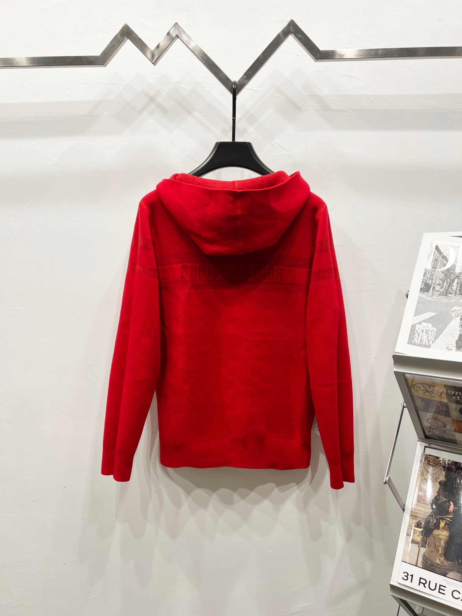 Red zip-front hooded sweatshirt, back view with hood and jacquard logo pattern