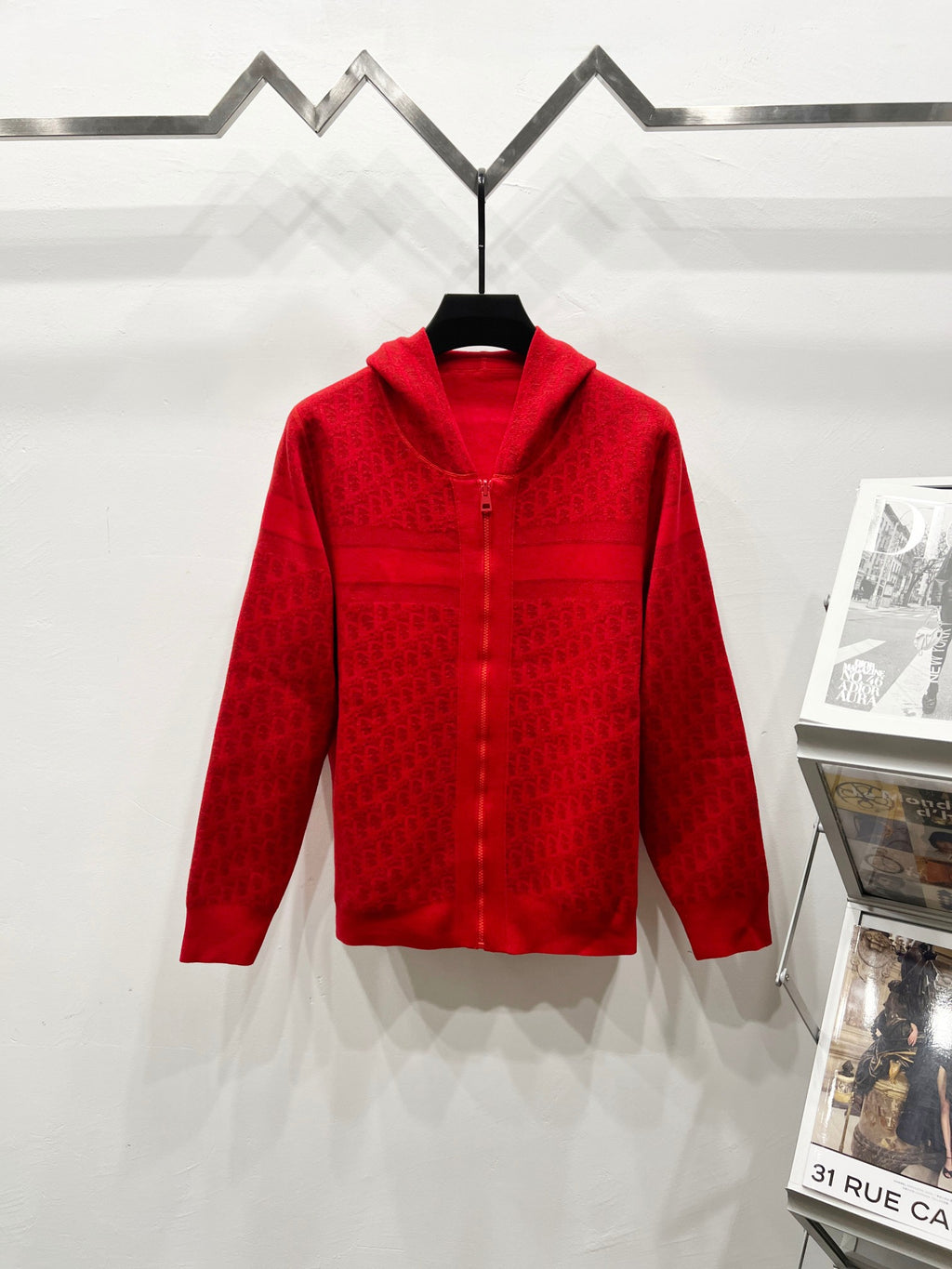 Red zip-front hooded sweatshirt, front view with repeating jacquard logo pattern