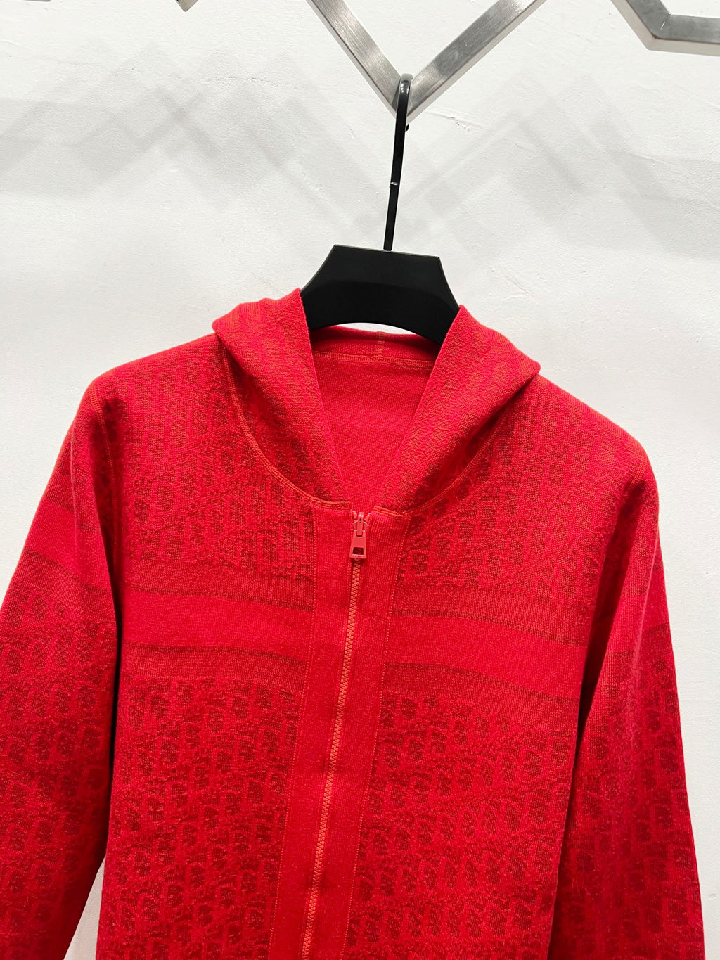 Red zip-front hooded sweatshirt close-up, chest logo jacquard and front zipper