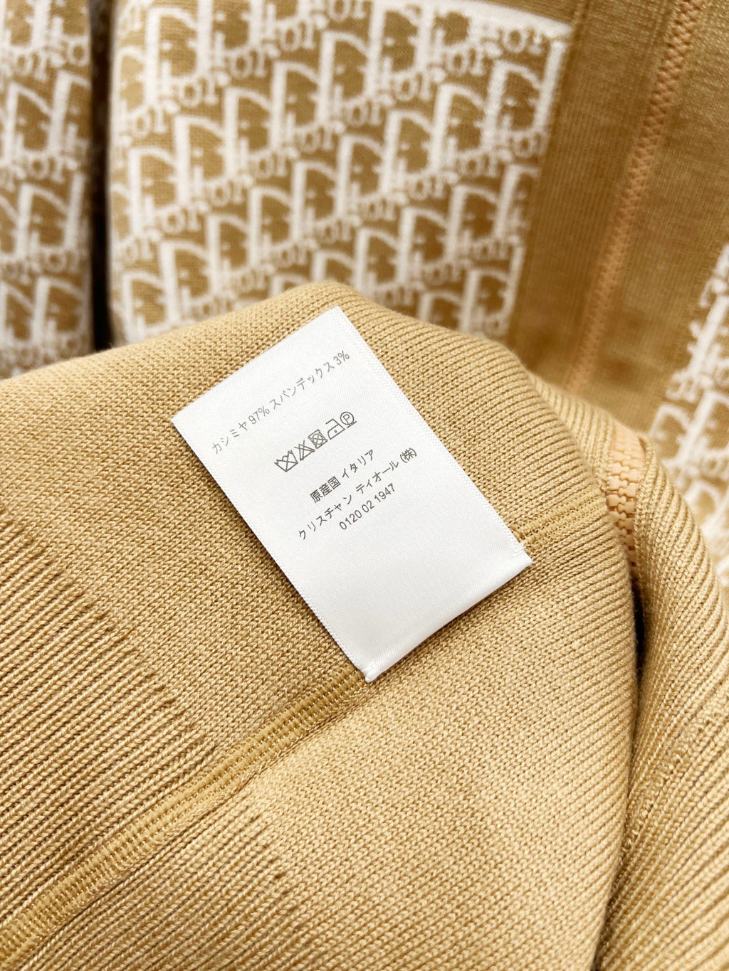 Tan fabric garment label on knit hooded sweatshirt