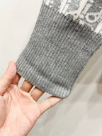 Gray ribbed knit cuff held in hand