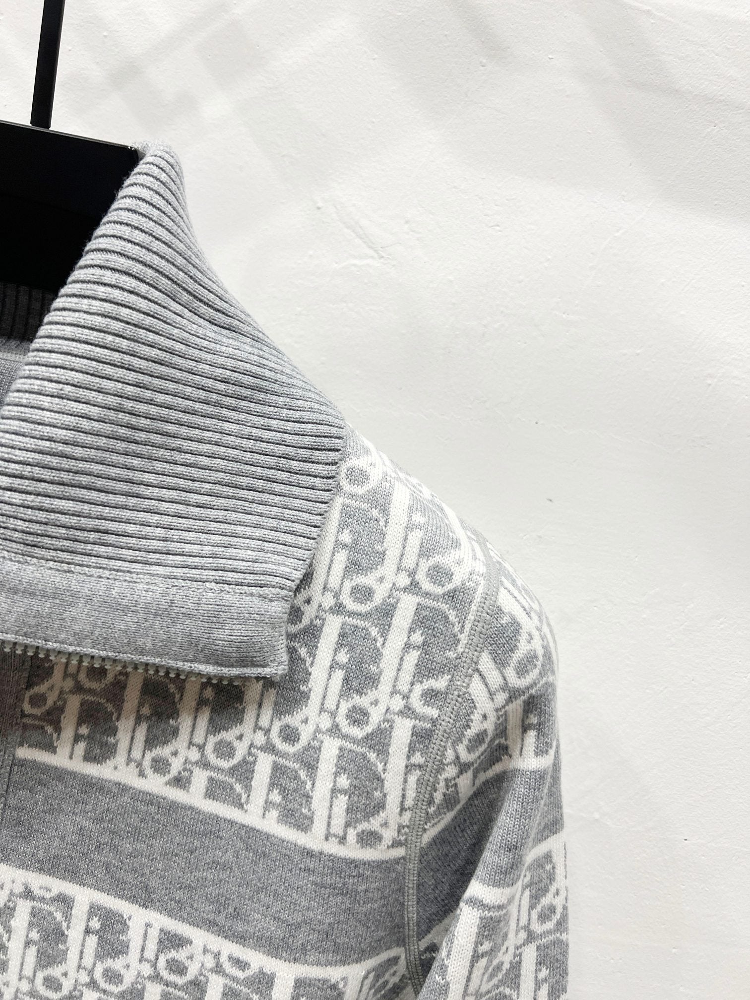 Gray knit sweater yoke with Dior monogram trim and central zipper placket